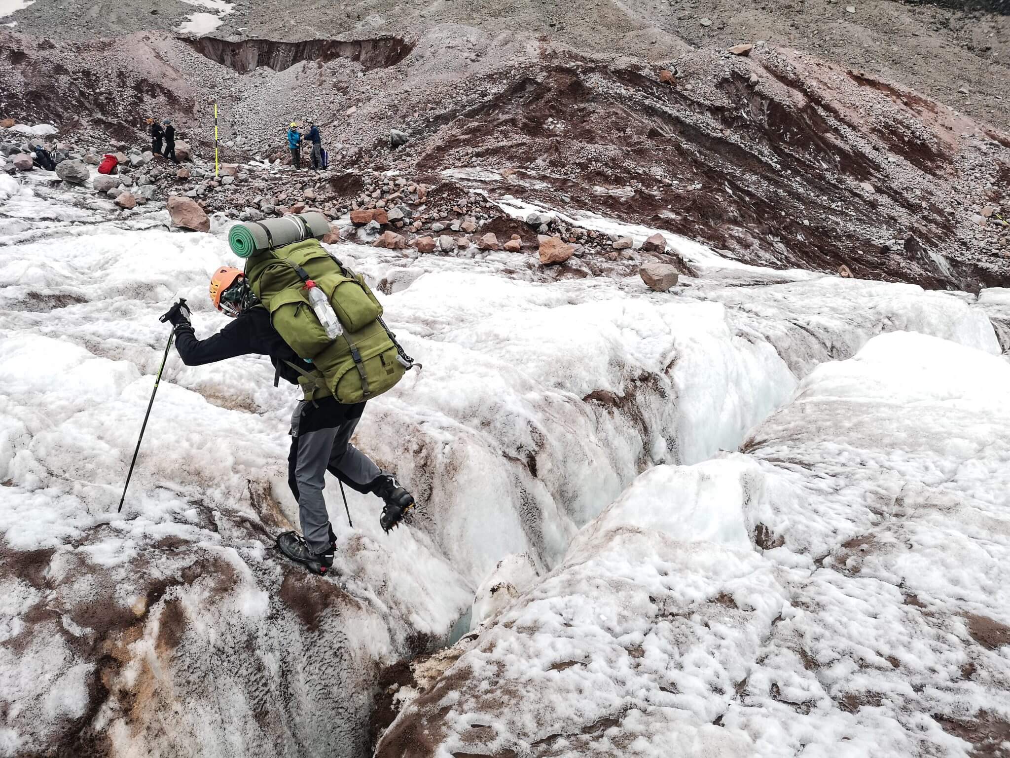 mountaineer jumping crevasse