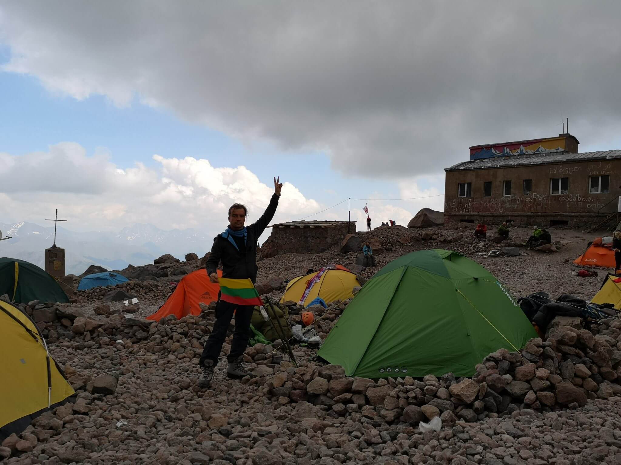 mountaineer near a camp and flag