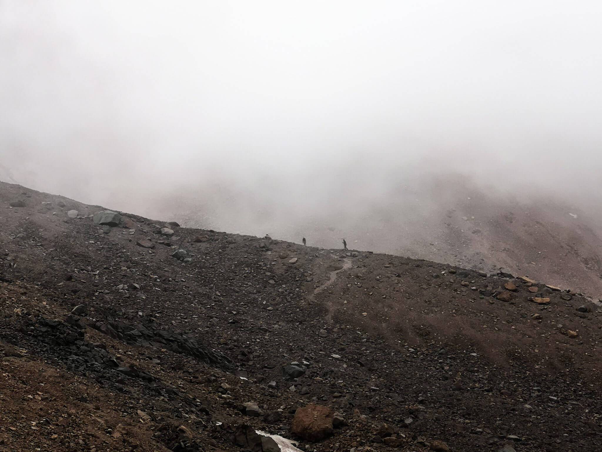 mountaineers climbing in clouds
