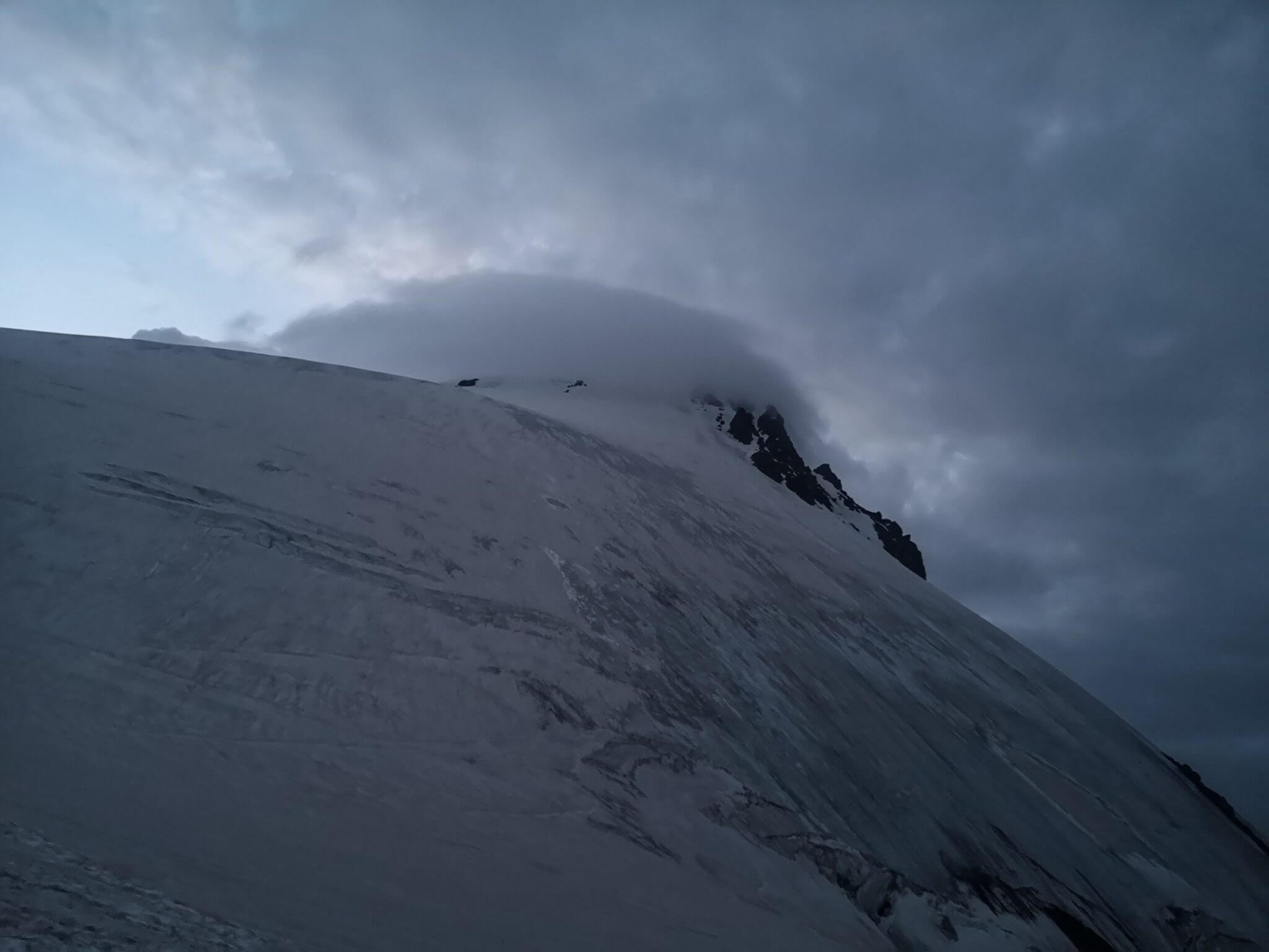 mountain top covered by clouds