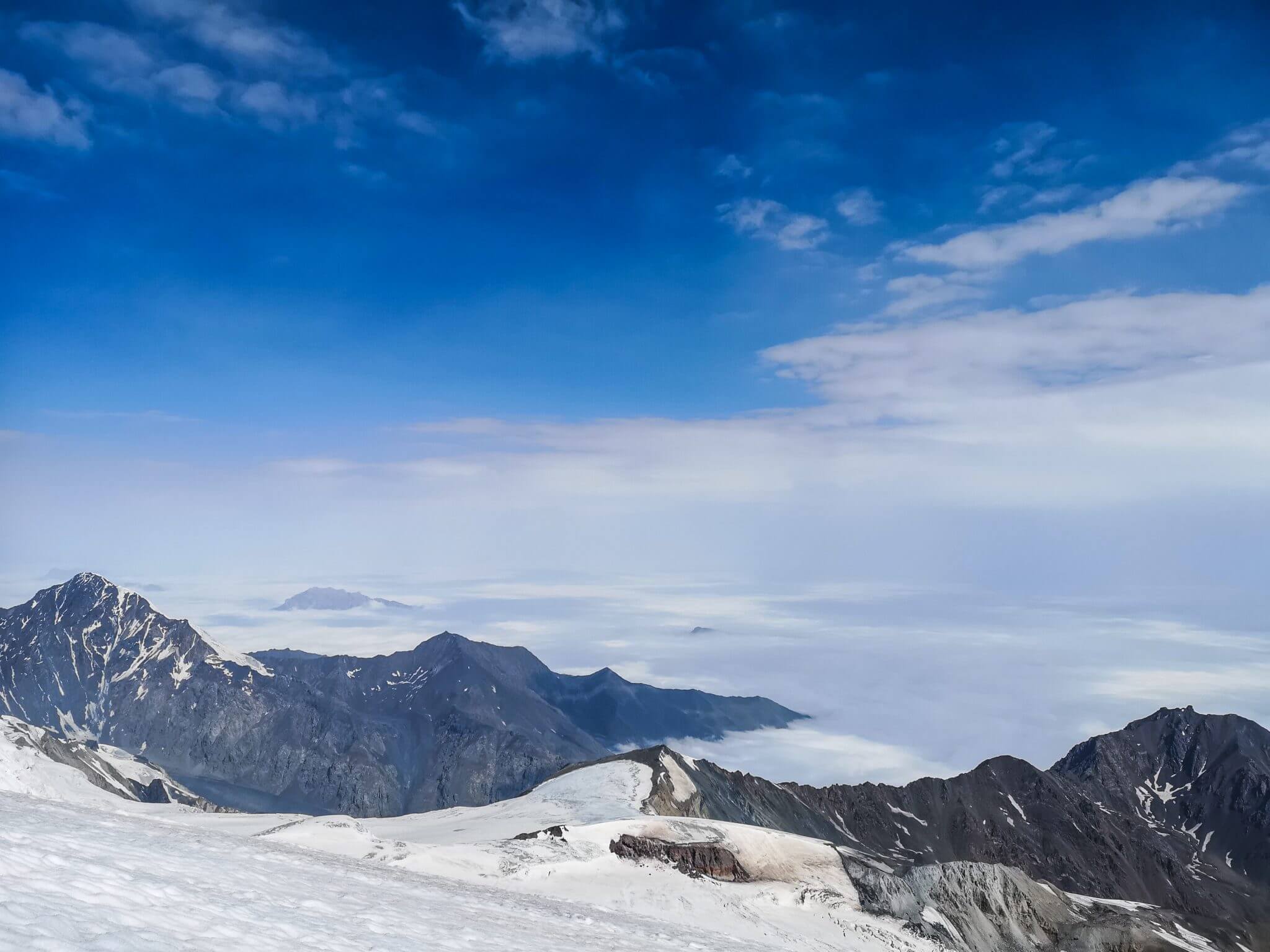mountains peaks above clouds
