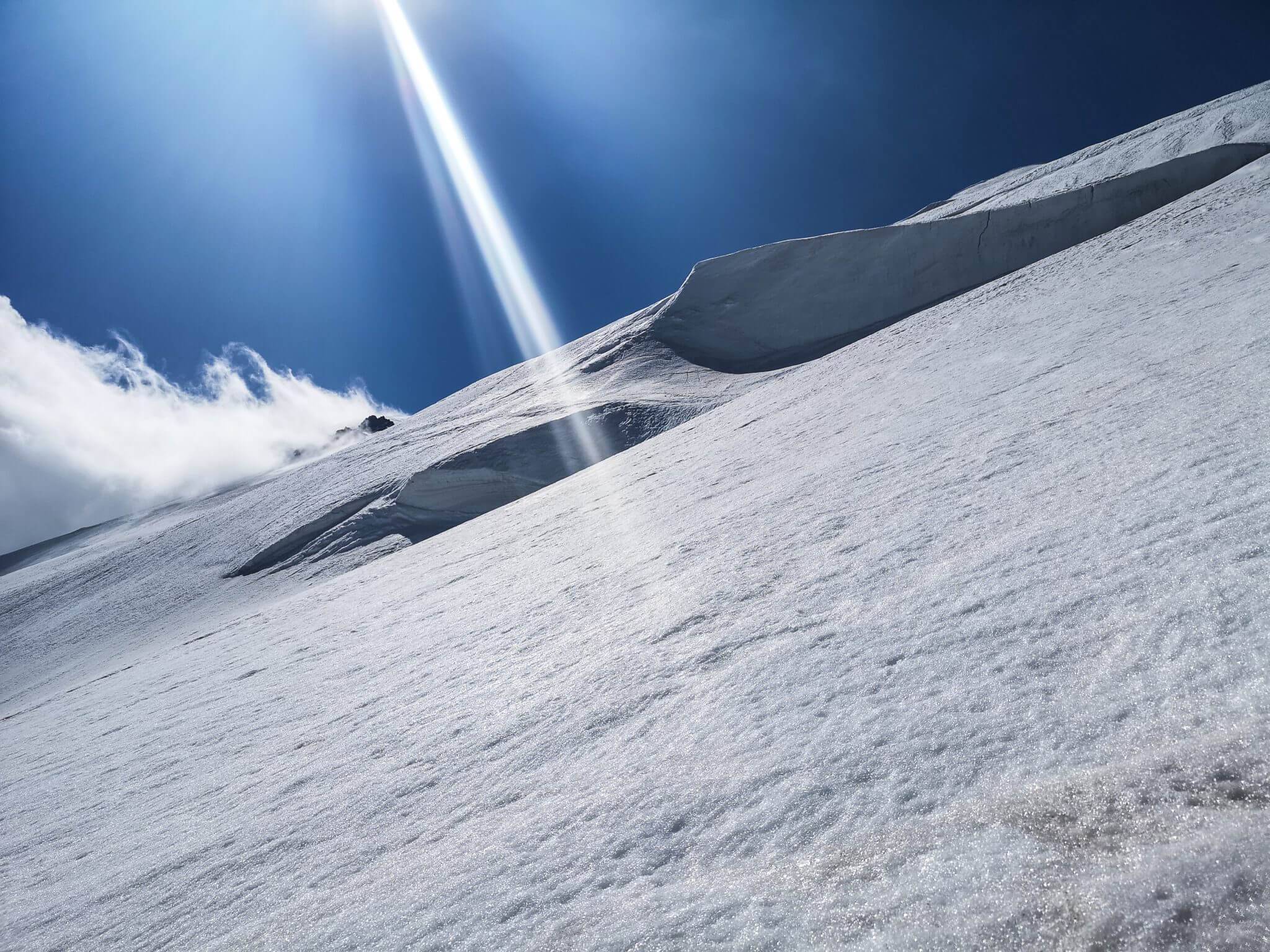 sun beam on snowy mountain