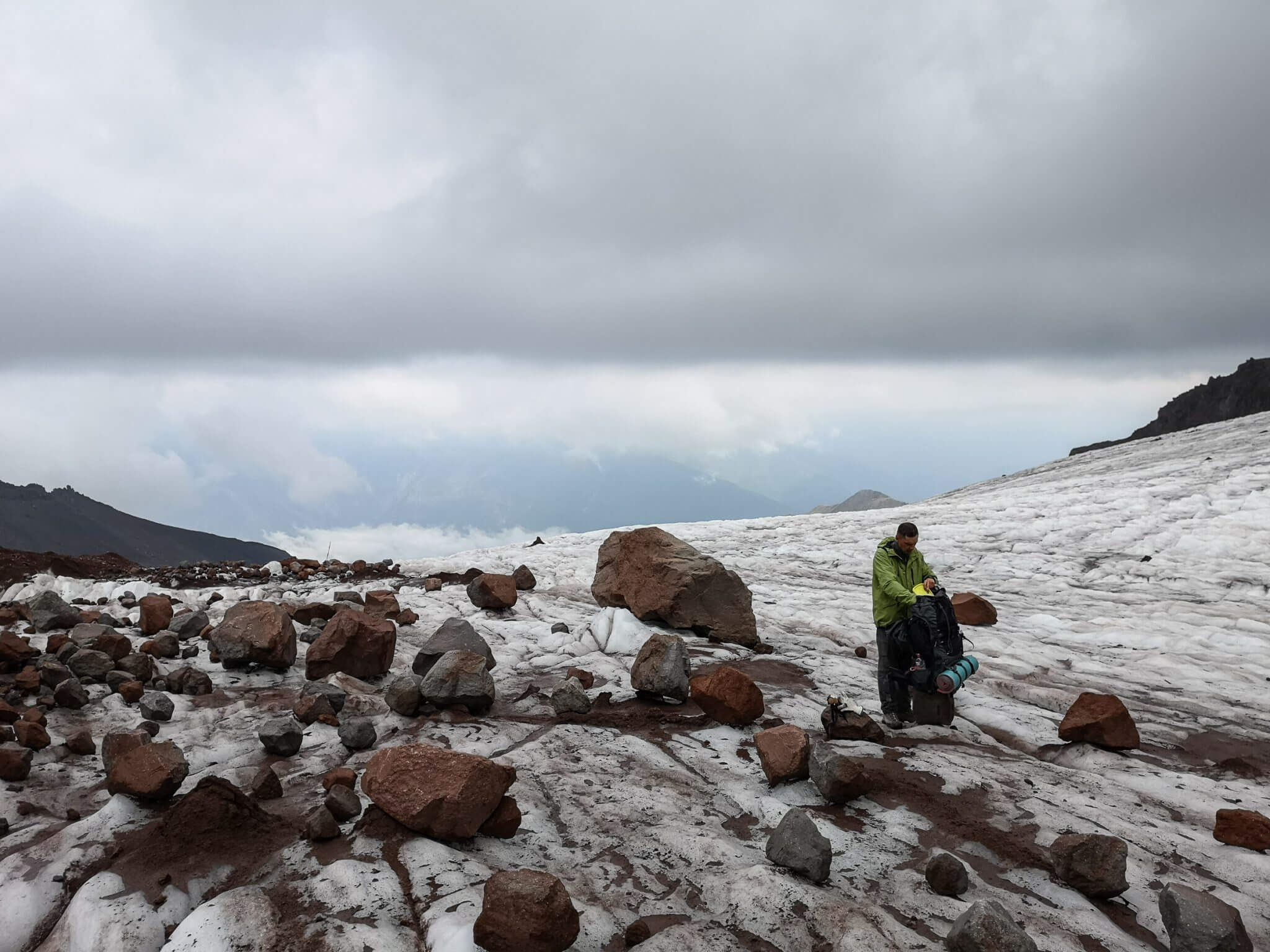 climber packing backpack mountains glacier