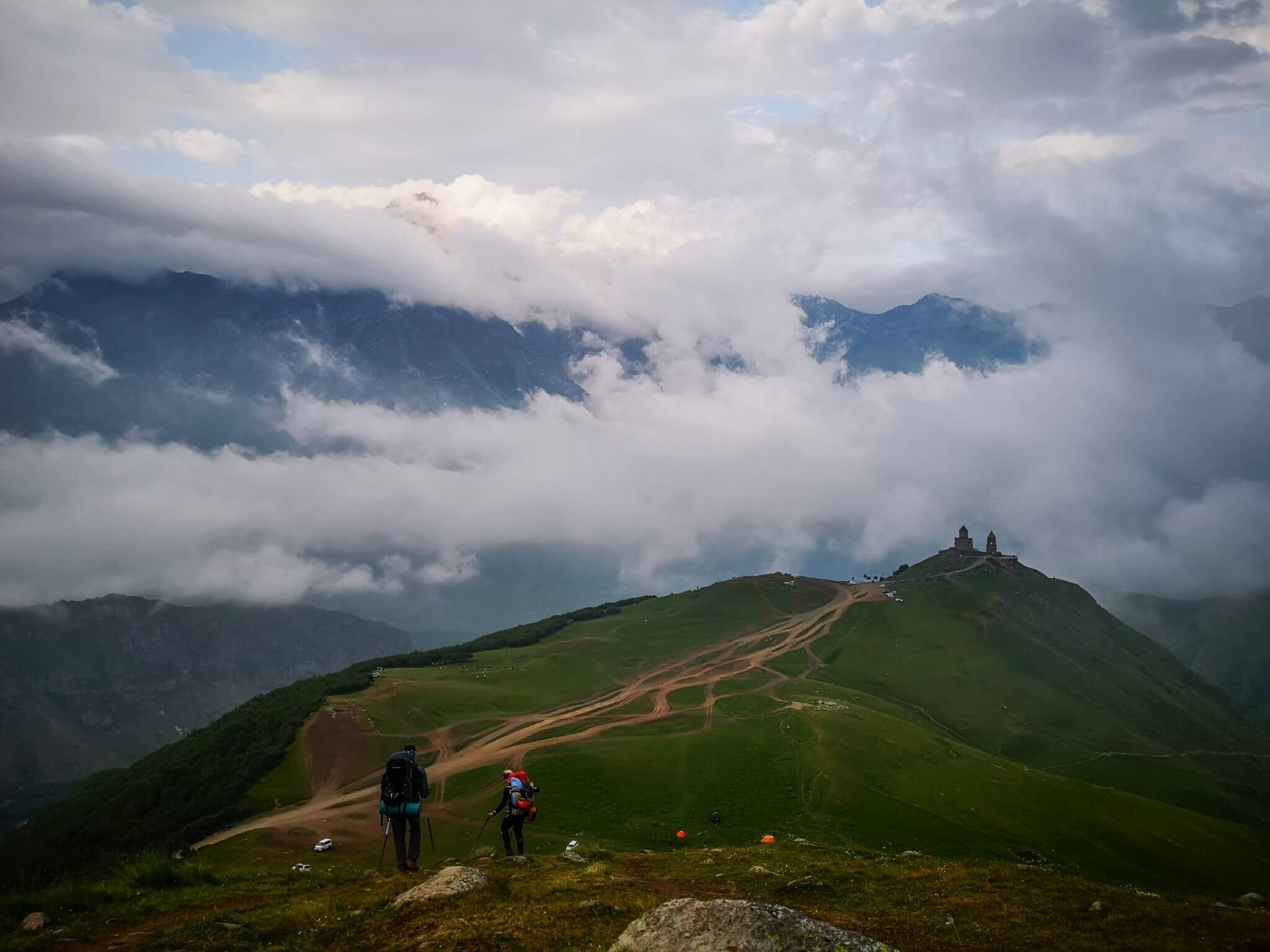 climbers descending to gergeti trinity church