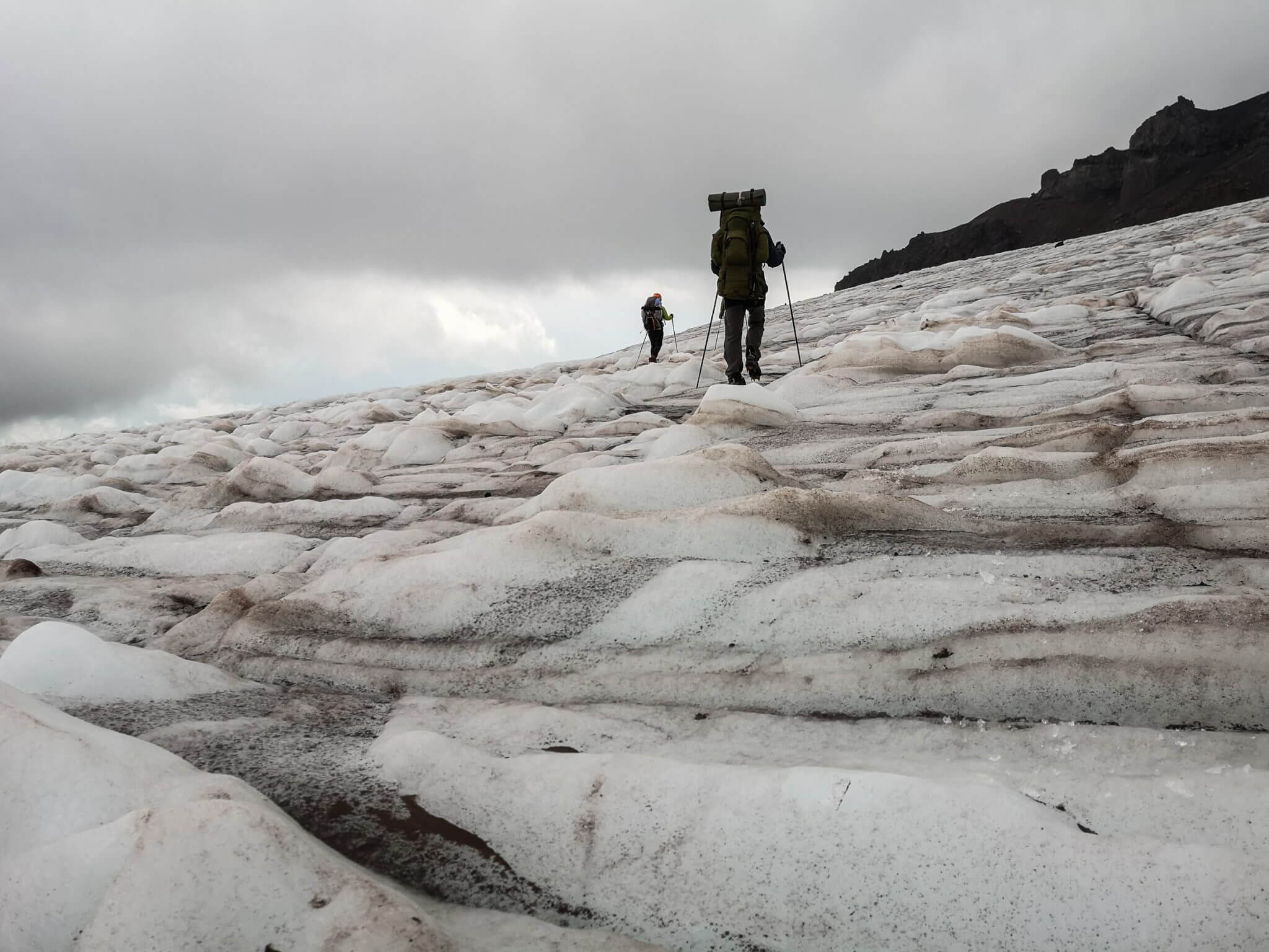 climbers walking mountain glacier