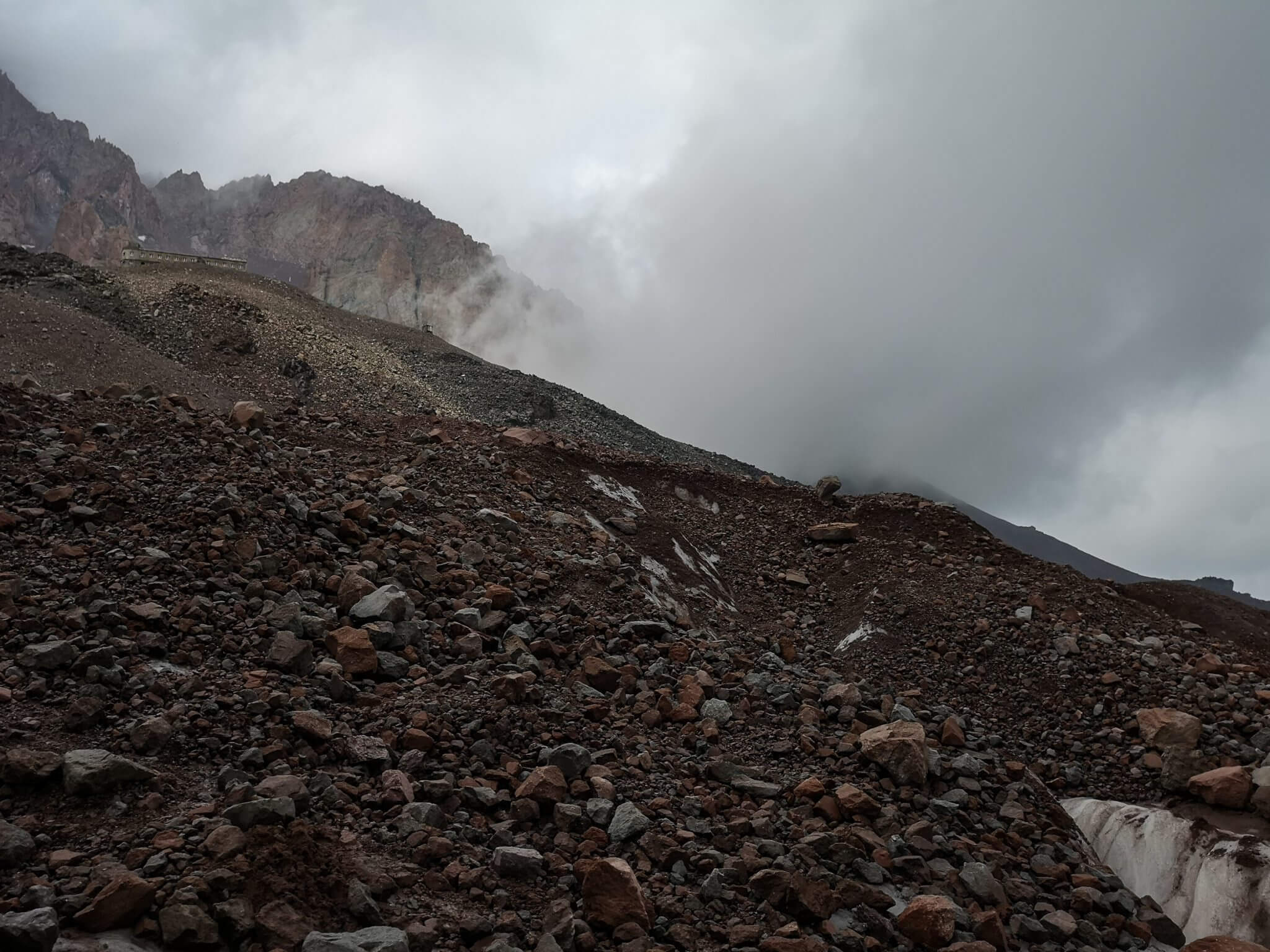 clouds mountains hut rocks