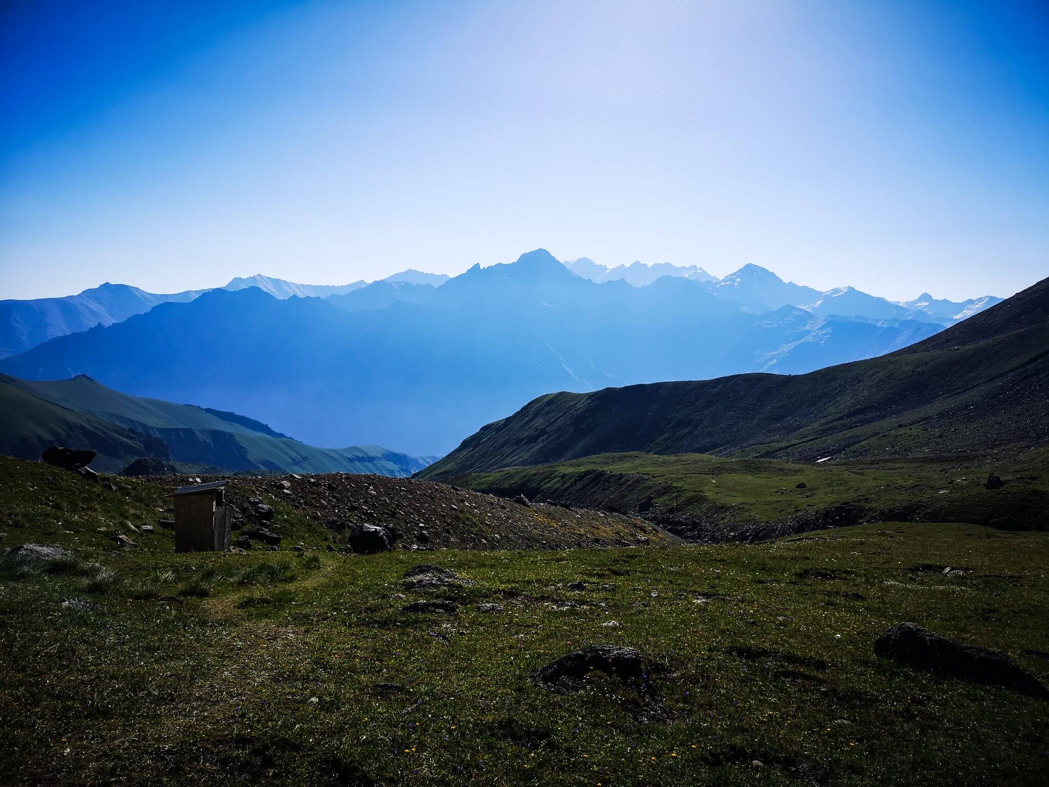 toilet on grass field in mountains