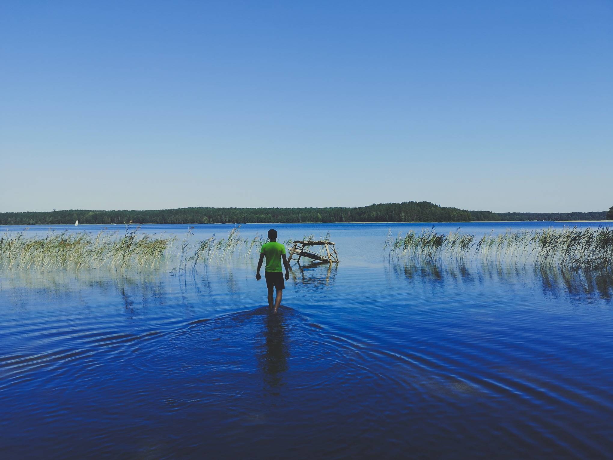Wading on White Lakajai Lake in Labanoras Regional Park, Lithuania