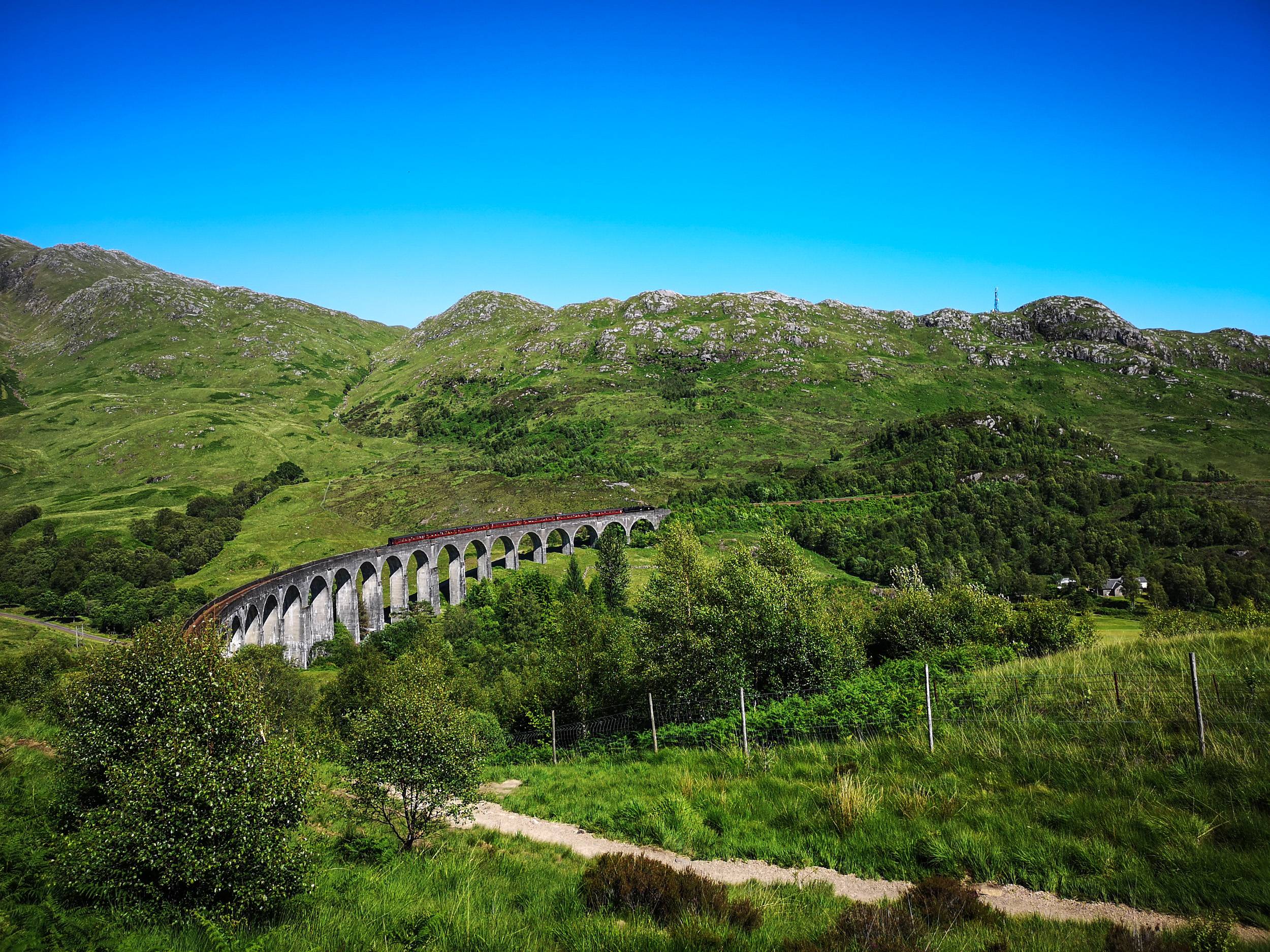 Harry Potter the Jacobite train on Glenfinnan Viaduct going from Mallaig to Fort WIlliam, Scotland