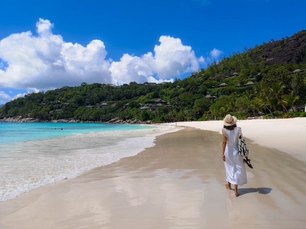 A beautiful girl walking in Petit Anse in Mahe, Seychelles